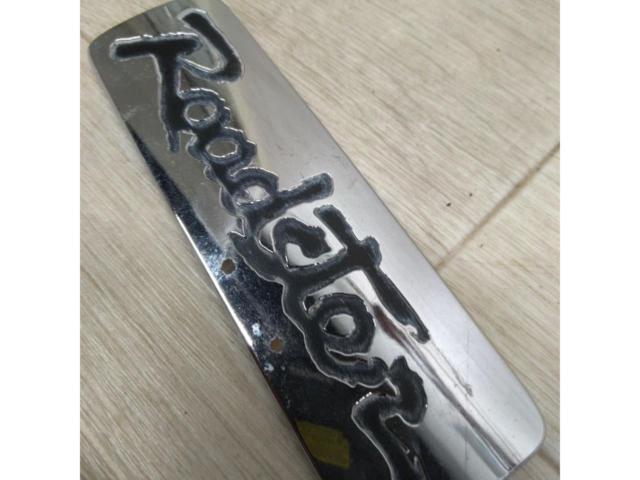  time thing 
Mazda Roadster
Roadster emblem