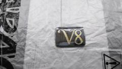 Nissan genuine
Rear trunk emblem
V8